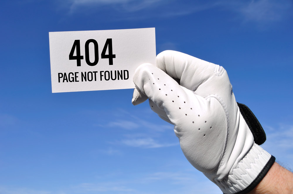 Hand with golf club holding a card that says 404 page not found.